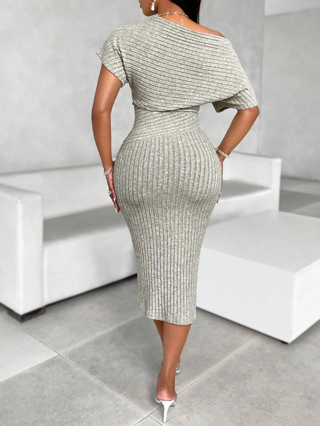 Woman wearing a patterned dress in an indoor setting